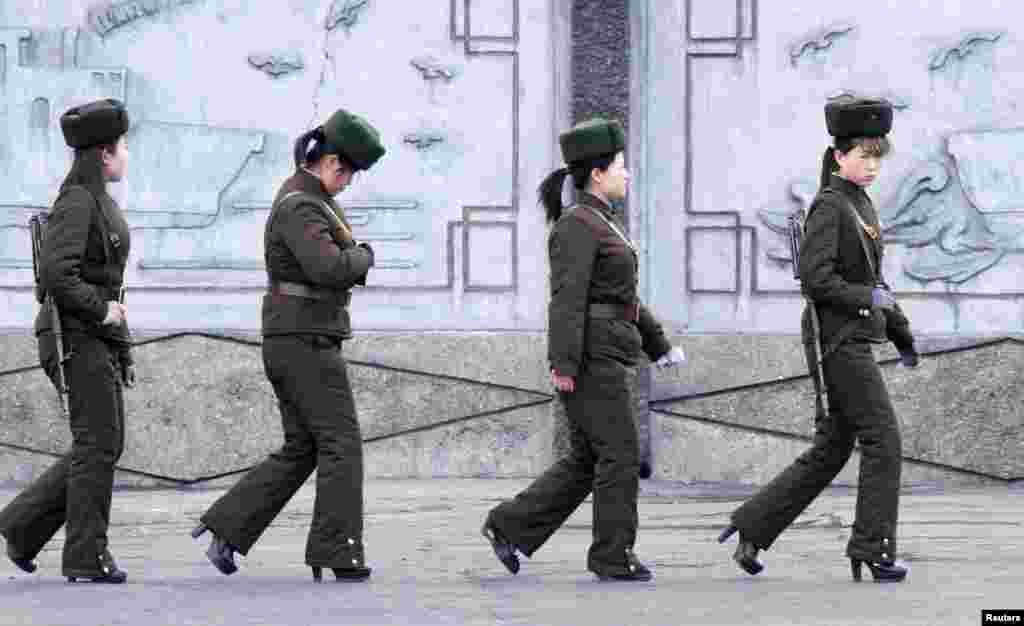 Female North Korean soldiers patrol along the banks of Yalu River, near the North Korean town of Sinuiju, opposite the Chinese border city of Dandong, April 11, 2013.