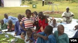 FILE - A group of 133 Nigerian refugees, mostly children, who are to be transported to Yola in Nigeria's Adamawa state waits in Maroua, Cameroon, Aug. 22, 2019. (Moki Kindzeka/VOA) 