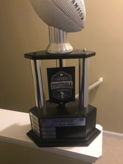 Fantasy football players like Nima Vaez-Zadeh often vie for the right to win their league's trophy for a year.