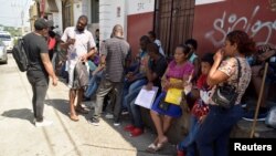 Migrants from Central America and Cuba queue outside the Mexican Commission for Refugee Assistance (COMAR) to apply for asylum and refugee status in Mexico, in Tapachula, Mexico September 13, 2019.