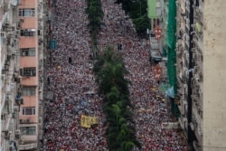 Protesters march during a rally against a controversial extradition law proposal in Hong Kong.