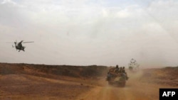 A helicopter of the French army escorting a vehicle transporting Mali's Prime Minister Moussa Mara from Gao to Kidal, May 17, 2014.