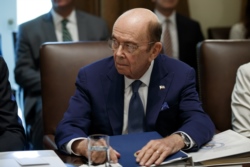 FILE - U.S. Commerce Secretary Wilbur Ross listens during a Cabinet meeting in the Cabinet Room of the White House, July 16, 2019, in Washington.