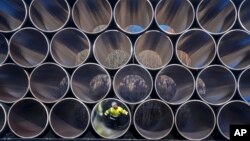 FILE - Tubes are stored in Sassnitz, Germany, to construct the natural gas pipeline Nord Stream 2 from Russia to Germany, Dec. 6, 2016.