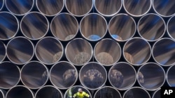 FILE - Tubes are stored in Sassnitz, Germany, to construct the natural gas pipeline Nord Stream 2 from Russia to Germany, Dec. 6, 2016.