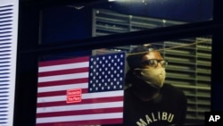 A protester who was arrested waits in the back of a bus during a rally at the Barclays Center over the death of George Floyd, May 29, 2020, in the Brooklyn borough of New York. 