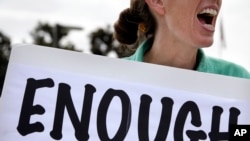 FILE - Vicki Maturo of Culver City, Calif., protests the government shutdown outside the federal building in Los Angeles, Oct. 2, 2013.
