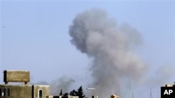 Smoke rises from an area in southeast Tripoli, Libya, April 14, 2011