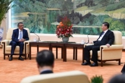 FILE - Tedros Adhanom, WHO director-general meets with Chinese President Xi Jinping before a meeting at the Great Hall of the People in Beijing, Jan. 28, 2020.
