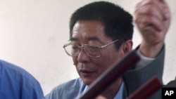 FILE - Xiang Nanfu at an Easter meal at a brick home in Houbaihujian village, on the outskirts of Beijing, China, April 11, 2004.