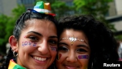 Isabella Nicolaou and Lily Navarro pose for a portrait as they attend a LGBTQ + Pride event in Washington, U.S., June 12, 2021. REUTERS/Erin Scott