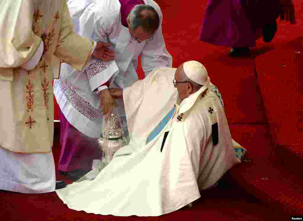 Pope Francis is helped after falling as he arrives at the Jasna Gora shrine in Czestochowa, Poland.