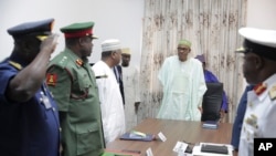 FILE - Nigerian President Muhammadu Buhari presides at a meeting with his nation's service chiefs in Abuja, June 2, 2015. 