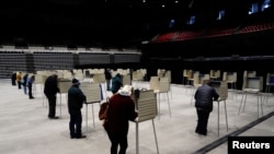 Voters cast their ballots at socially distanced privacy booths at a early voting site inside the Bismarck Event Center as the coronavirus disease (COVID-19) outbreak continues in Bismarck, North Dakota, Oct. 26, 2020.