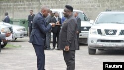 Congolese opposition Union for the Congolese Nation (UNC) president Vital Kamerhe (L) talks to opposition party Reformist Forces for Union and Solidarity's (FONUS) Joseph Olenga Nkoy at a break during talks between the opposition and the government of President Joseph Kabila at the Conference episcopale nationale du Congo (CENCO) headquarters in the Democratic Republic of Congo's capital Kinshasa, Dec. 31, 2016.