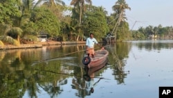 A man travels to help people get clean water in Kochi, Kerala state, India, on March 1, 2023. Saltwater's intrusion into freshwater means residents can no longer depend on ponds and wells for the water they need to drink, cook and wash. (Uzmi Athar/Press Trust of India via AP)
