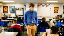 FILE - A substitute teacher at the Greenfield Intermediate School in Greenfield, Ind., teaches on Dec. 10, 2020.