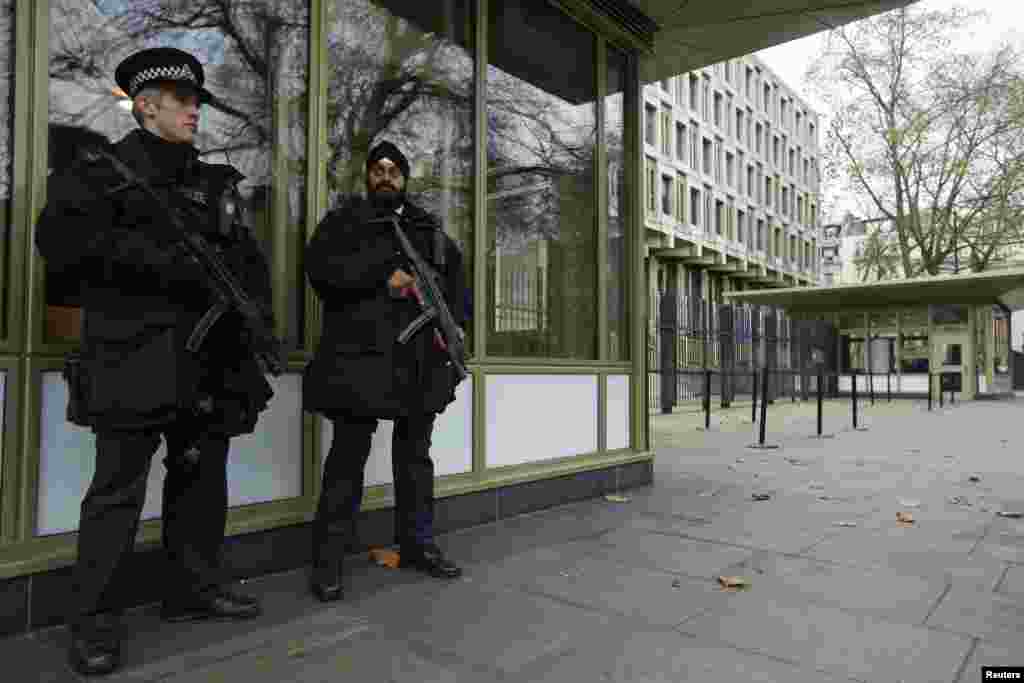 Police officers stand vigilant outside the U.S. embassy in London as the Senate Intelligence Committee prepares to release a report on the CIA's anti-terrorism tactics, Dec. 9, 2014.