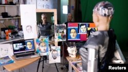 Humanoid robot Sophia, developed by Hanson Robotics, draws on a piece of paper before auctioning her own non-fungible token (NFT) artwork, in Hong Kong, China March 16, 2021. REUTERS/Tyrone Siu