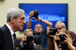 Former special counsel Robert Mueller returns to the witness table following a break in his testimony before the House Intelligence Committee on Capitol Hill, July 24, 2019.