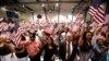 FILE - People hold flags as they are sworn in as U.S. citizens during a naturalization ceremony in Phoenix, Arizona.