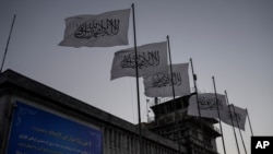 Taliban flags flutter at the airport in Kabul, Afghanistan, Sept. 9, 2021. 