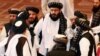 FILE - Taliban delegates speak during talks between the Afghan government and Taliban insurgents in Doha, Qatar, Sept. 12, 2020. 