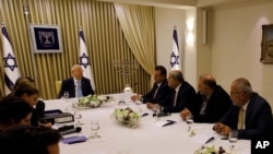 Israeli President Reuven Rivlin, cener left, speaks with members of the Joint List Ayman Odeh, fourth right, Ahmad Tibi, third right, Mansour Abbas, second right, and Osama Saadi, right, during a consultation meeting with in Jerusalem, Sept. 22, 2019.