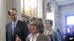 Sen. Barbara Boxer, D-Calif., right, and Sen. Ron Wyden, D-Ore., left, arrive to vote on the spending bill in the Senate at the Capitol in Washington, Wednesday, March 9, 2011.