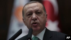 FILE - Turkey's President and leader of ruling Justice and Development Party Recep Tayyip Erdogan addresses the members of his ruling party at the parliament in Ankara, Turkey, Feb. 13, 2018.