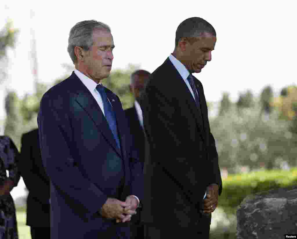 U.S. President Barack Obama and former president George W. Bush (left) attend a memorial for the victims of the 1998 U.S. embassy bombing in Dar es Salaam, July 2, 2013. 