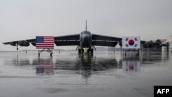 FILE - National flags of the United States and South Korea are displayed in front of a B-52H strategic bomber parked at a South Korean Air Force base at Cheongju Airport on October 19, 2023.