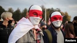 FILE - People attend an opposition rally to reject the Belarusian presidential election results in Minsk, Belarus. Oct. 25, 2020. 