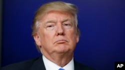 FILE - President Donald Trump pauses during a town hall with business leaders in the South Court Auditorium on the White House complex in Washington, April 4, 2017.