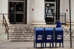 FILE - Mailboxes are seen on a sidewalk in New York City, Aug. 14, 2020.