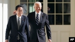 FILE - President Joe Biden and Japanese Prime Minister Fumio Kishida walk along the Colonnade of the White House, Jan. 13, 2023, in Washington. Biden will host Kishida and Philippines President Ferdinand Marcos Jr. at a White House summit next month.