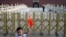 A child holds up a Chinese national flag as he poses for a photo in front of Tiananmen Gate in Beijing, June 4, 2014.