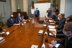 FILE - U.S. Special Envoy for the Horn of Africa Jeffrey Feltman, left, meets with Egyptian Foreign Minister Sameh Shoukry, third right, and their delegations, at the foreign ministry in Cairo, Egypt, May 5, 2021.