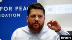 FILE - Leonid Volkov, an ally of Russian opposition politician Alexey Navalny, speaks during a news conference in Berlin, Germany, Aug. 21, 2020.