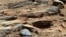 FILE - An image from NASA's Mars rover Curiosity shows the surface of the planet in this NASA handout released January 15, 2013.