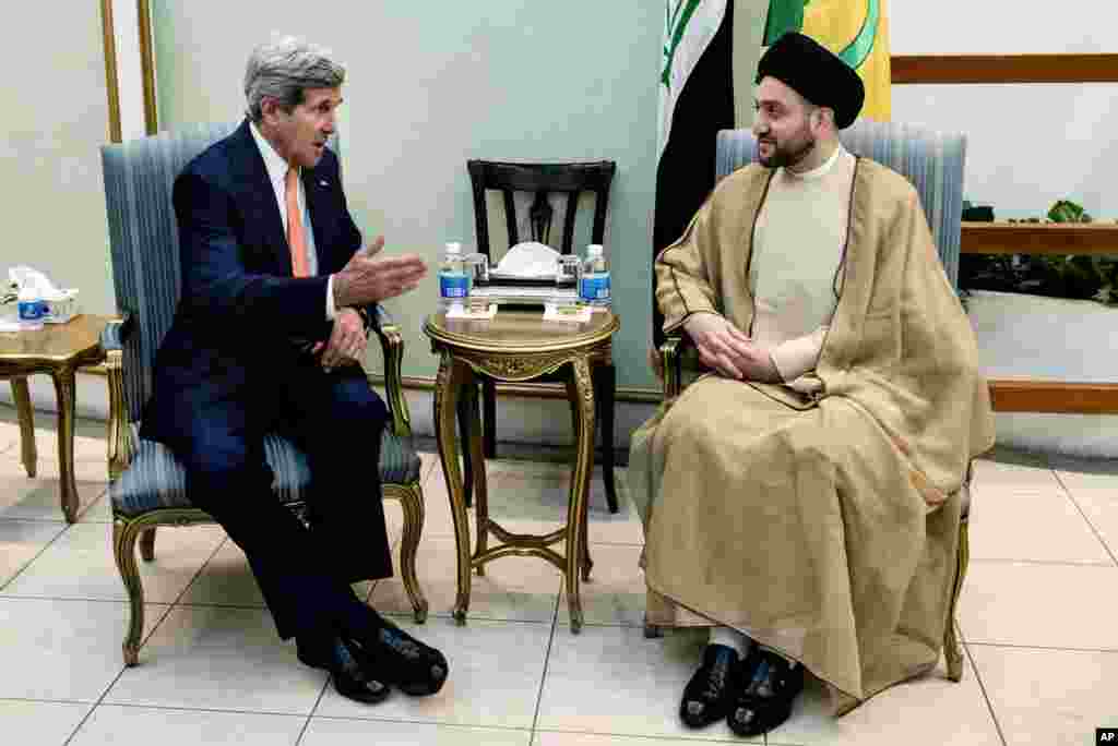 U.S. Secretary of State John Kerry speaks with Sayyed Amar Al-Hakim, head of Supreme Islamic Council, during a meeting in Baghdad, June 23, 2014. 