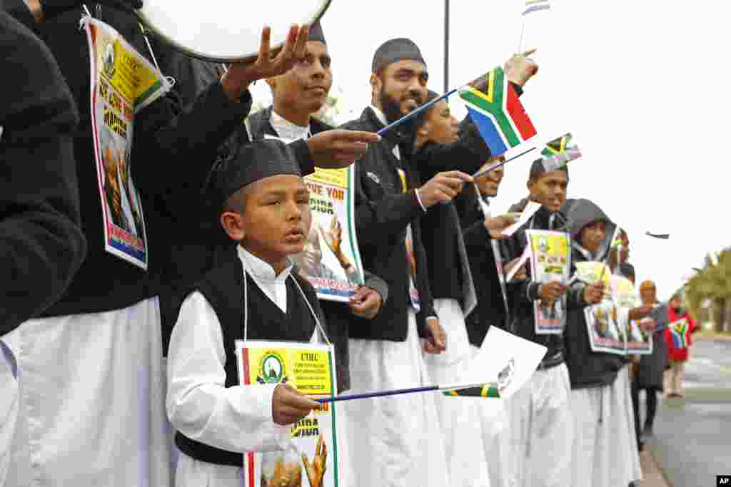 A child sings as he and others celebrate Nelson Mandela's 95th birthday in Cape Town, July 18, 2013.