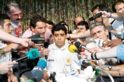 FILE - Argentina World Cup soccer player Diego Maradona is the center of media attention at the Sheraton Park Plaza hotel in Dallas, Texas, June 30, 1994.