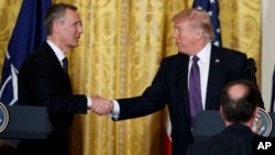 President Donald Trump shakes hands with NATO Secretary General Jens Stoltenberg during a news conference in the East Room of the White House, April 12, 2017, in Washington. 