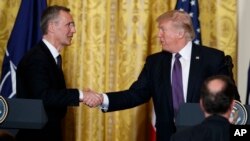 President Donald Trump (R) shakes hands with NATO Secretary General Jens Stoltenberg during a news conference in the East Room of the White House, April 12, 2017, in Washington. 