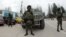 Unidentified armed individuals with armored vehicles block base of Ukrainian border guard service, Sevastopol, March 1, 2014.