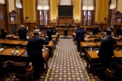 Members of Georgia's Electoral College are sworn in before casting their votes at the state Capitol, Dec. 14, 2020, in Atlanta. (AP Photo/John Bazemore, Pool)