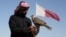 FILE - A Qatari man prepares his falcon to participate in a contest during Qatar International Falcons and Hunting Festival at Sealine desert, Qatar, Jan. 29, 2016. The kidnapping of 26 Qataris in December 2015 in the Iraqi desert while hunting, including members of the country's royal family, has highlighted the risks of pursuing the "sport of kings" at a time of heightened regional turmoil. 