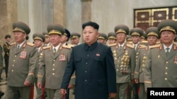 FILE - North Korean leader Kim Jong Un, with troops, visits the Kumsusan Palace on the anniversary of the armistice signing that ended the Korean War.