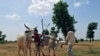 Children play with cows used for plowing at farms in Saulawa village, on the outskirts of Nigeria's north-central state of Kaduna, May 15, 2013.